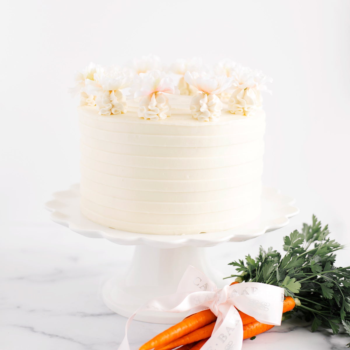 Decorated carrot cake with silk cherry blossom flowers