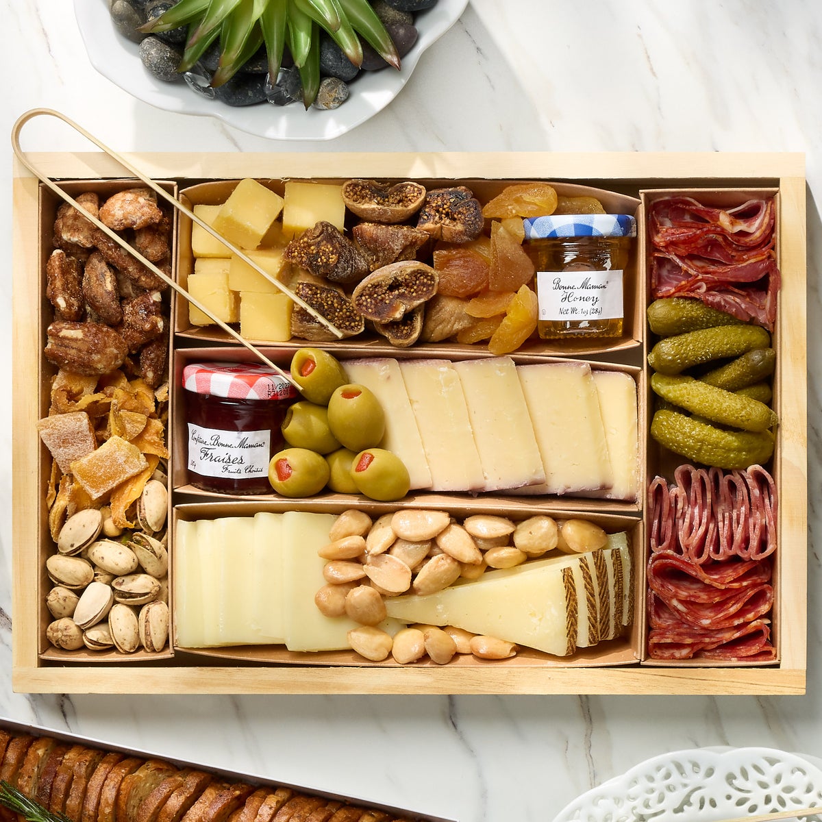 Premium snack board with crackers, fruit, and jams