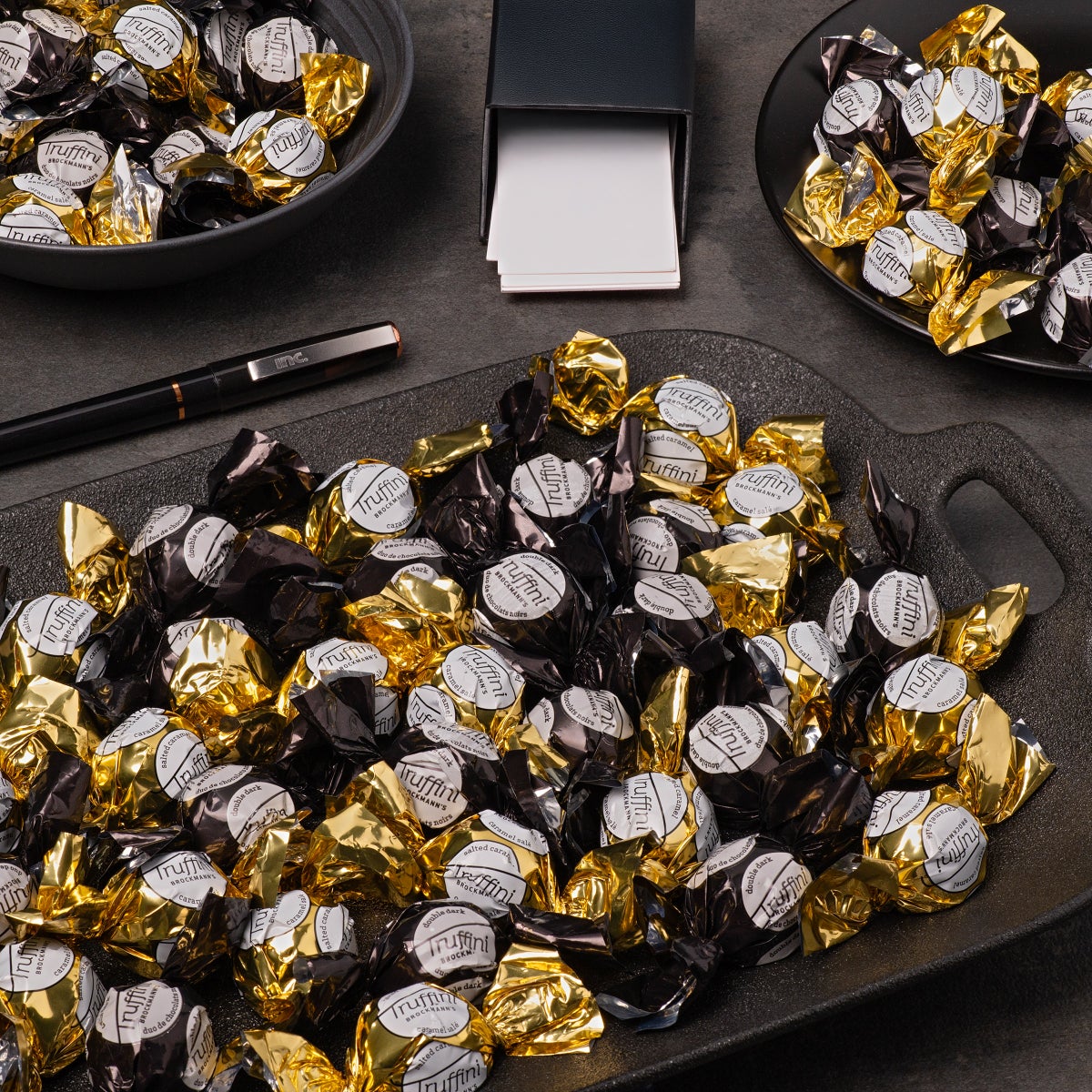 Individually wrapped dark chocolate truffles in black foil