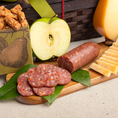 Woven hamper gift basket with savory snacks and apples