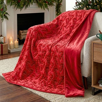 Holiday embroidered faux fur throw with candy cane design