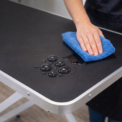 Foldable grooming table with adjustable height settings