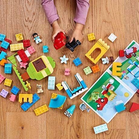 LEGO DUPLO set with car flowers balloons and cake