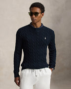 Rib-knit hem on cable-knit cotton sweater